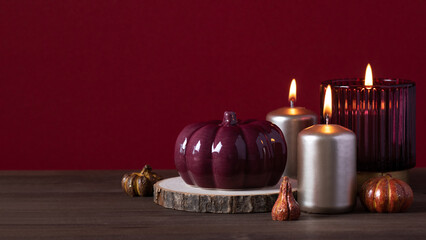 Autumn home decor with ceramic pumpkins, burning candles. Cozy autumn home concept