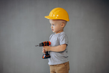 Cute little boy with toy building tools