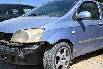 View on car damages in front part of the vehicle. Fender, halogen light and door back mirror are...