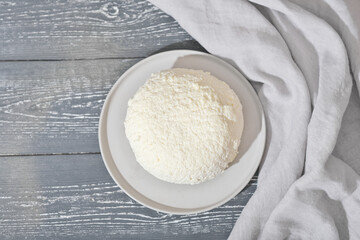 homemade soft cheese on a concrete plate. cottage cheese, high protein dairy product. healthy meal, low carb diet plan.
