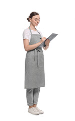 Beautiful young woman in clean apron with clipboard on white background