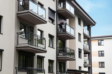 Exterior of white and black building with glass balconies