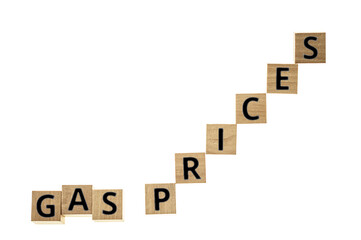 Gas prices in black letters on wooden blocks on white background with space for copy