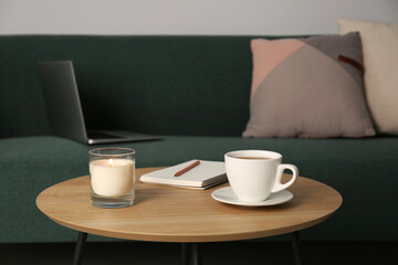 Fototapeta Wooden side table near sofa with laptop in room. Interior design obraz