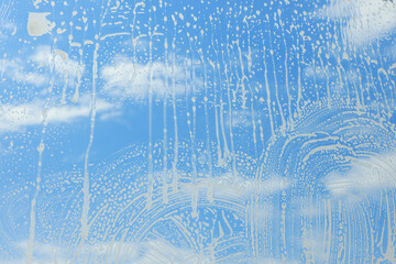 Cleaning foam on window glass, closeup view