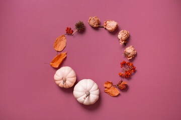 Autumn flat lay wreath of pumpkin, leaves and flowers with berries top view with copy space