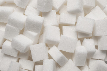 White sugar cubes as background, top view