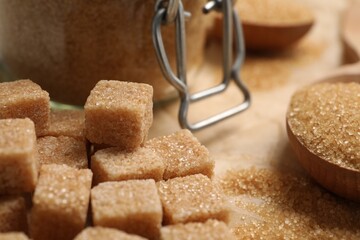Refined brown sugar cubes on table, closeup