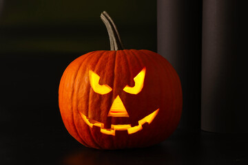 Scary jack o'lantern pumpkin in darkness. Halloween decor