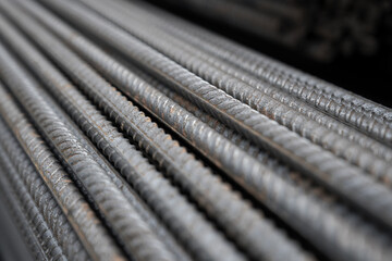 Reinforcing Steel Bar closeup. Reinforcement steel rod and deformed bar with rebar at construction site. Steel construction reinforcement with longitudinal ribs and transverse protrusions.