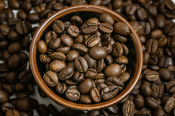 Fototapeta premium coffee beans isolated close up in a cup, a pile of coffee background