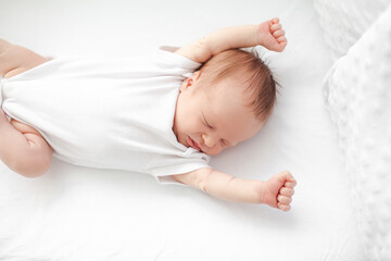 Home portrait of a sleeping newborn baby in a crib