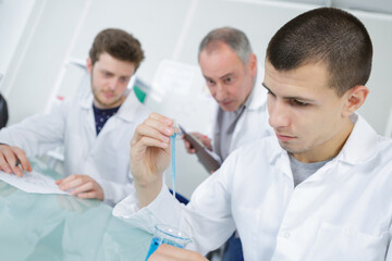 male medical or scientific laboratory researchers performs tests