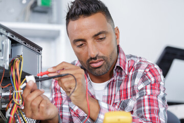 engineer measuring multimeter panel board