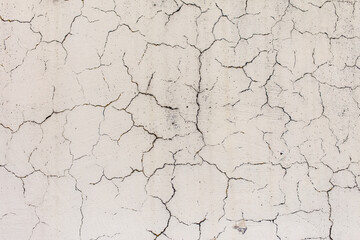 Cracked plaster on the wall of the house.