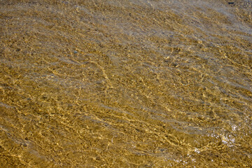 Close up of the amazing sandy and crystal clear waters of the Mylopotas  Beach in Ios Greece