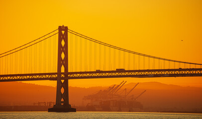 San Francisco Oakland Bay Bridge landmark, beautiful sunrise with spectacular sky. Travel to California, United States.