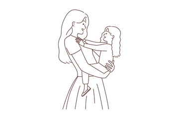 Smiling mother holding small daughter in hands