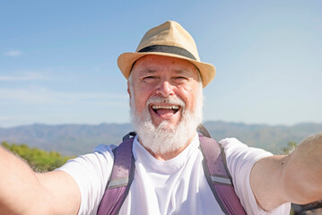 Handsome retired hiker taking selfie portrait using his smartphone