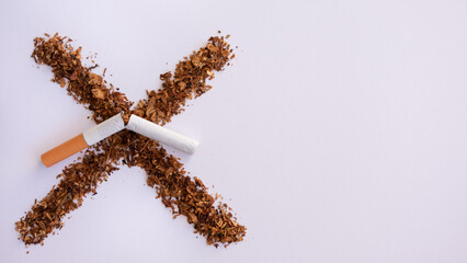 Tobacco cross on clear background and broken cigarette. Stop smoking. Cigarette, nicotine damages....