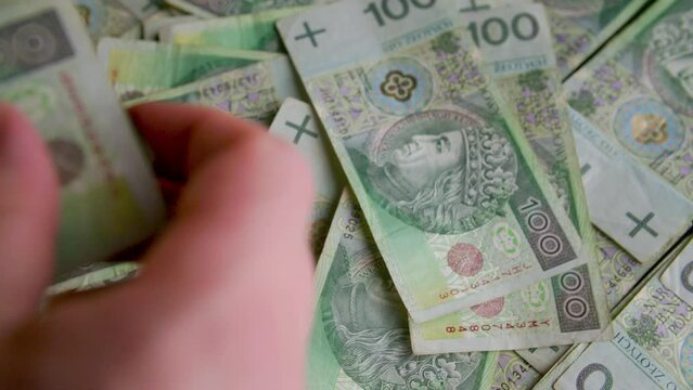 Counting Polish 100 Zloty Bills Cash. Throwing money on a table slow motion