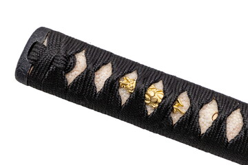 Close up shot of Tsuka - handle of Japanese sword wrapped by black silk cord on white ray skin with...