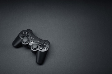 Black console video game joystick controller gamepad isolated on the dark solid black fond...