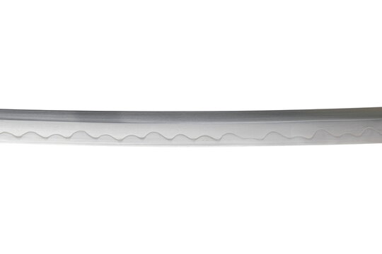 Japanese sword blade on white background. Soft focus.  The wavy pattern on the blade edge is a line of hardness that a blacksmith makes so that the blade doesn't break.  Each piece is unique.