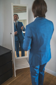 Bearded Mature Man Getting Dressed At The Mirror