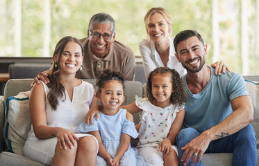 Happy big family, portrait and smile on sofa in home living room, spending quality time and bonding. Love, support and care of grandparents, parents and girls together on house couch smiling or laugh