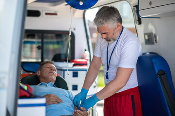 Patient receiving emergency medical care in the ambulance car