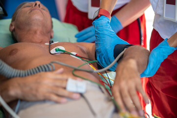 Paramedical staff checking the vital signs of an ill man