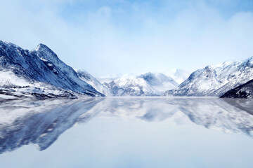 Fototapeta na wymiar snow covered mountains with sea where sea make reflection of all view