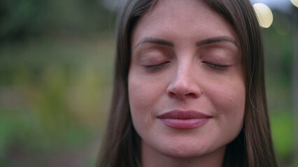 Fototapeta premium Portrait of a young woman with eyes closed in contemplation