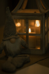 A cute dwarf and a lamp with candles on the table