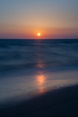 Long exposure by the sea. Waves break against stones. Sunset at the beach. Long exposure at night by the sea. Patara Beach Antalya Turkey