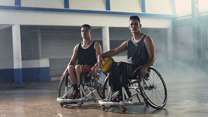 Two disabled handicapped basketball players in wheelchairs. Athletic paralyzed hispanic athletes