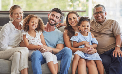 Interracial family, happy portrait and parents on the living room sofa with children, relax in...