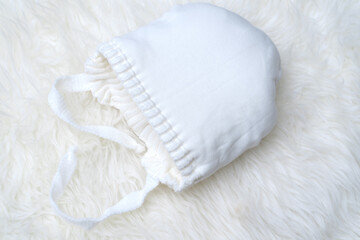 white baby woolen hat turned inside out. cotton lining