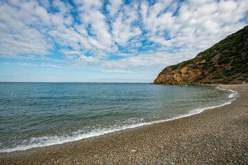 Sunset by the sea. long exposure. Pebble seascape. Sand and pebble beach.Galippoli, Canakkale Turkey. Fishing boat moored by the sea.	