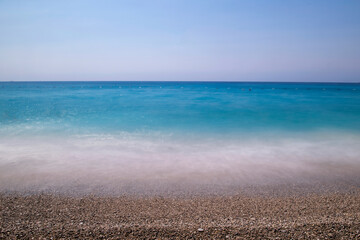 Long exposure by the sea. Waves break against stones. Sunset at the beach. Long exposure at night by the sea. Patara Beach Antalya Turkey