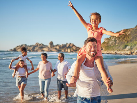 Happy, Travel And Love With Big Family At Beach For Colombia Holiday For Summer, Relax And Support. Sunset, Nature And Smile With Parents, Kids And Grandparents Walking By The Sea For Vacation