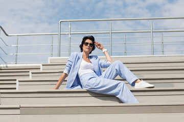 elegant  middle aged business woman  in a suit  walks and relaxing in street. Enjoying the little things. Lykke concept. Relaxation Concepts