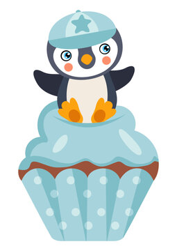 Cute baby boy penguin on top of blue cupcake