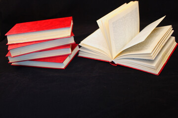 a stack of red books on a black background