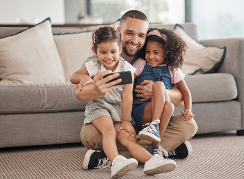 Family, selfie and happy children sitting on lounge carpet at home with phone and taking photo or doing video call together. Love, bonding and care of single parent man with girl kids in brazil house