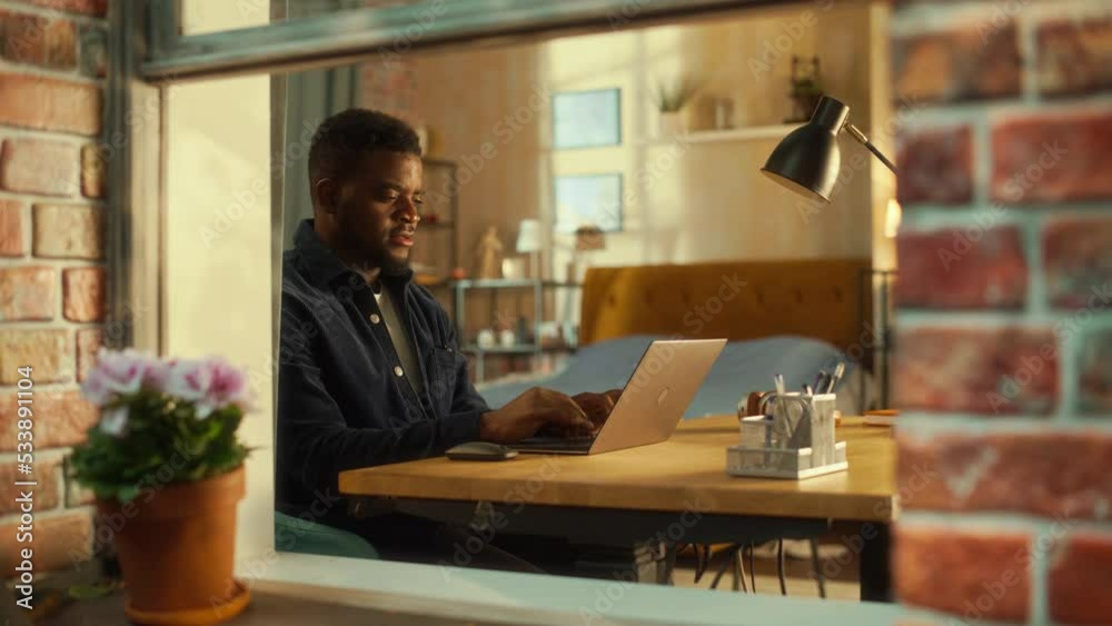 Poster tired african male using laptop at home. doing remote work during the day. frustrated man sitting at