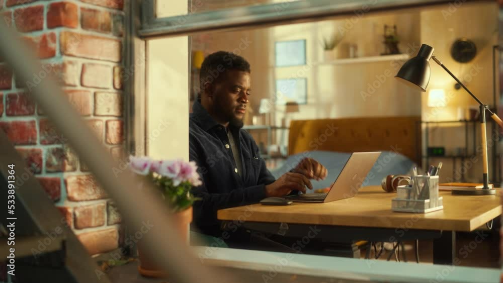 Leinwandbilder young black man using laptop at home. doing inspirational remote work during the day. specialist wor