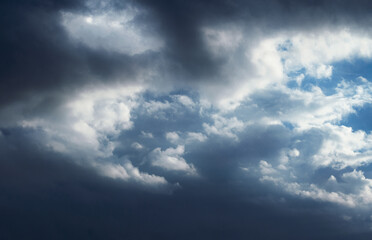 Naklejka na ściany i meble Heavy gale black stormy clouds cover the blue sky