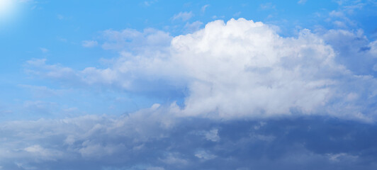 White massive clouds on blue sky